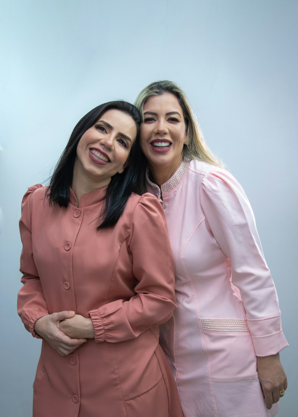 two women standing next to each other posing for a picture