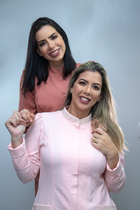 two beautiful women standing next to each other