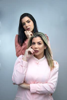 A mother and daughter wearing matching pastel peach cotton loungewear sets, smiling in natural light.