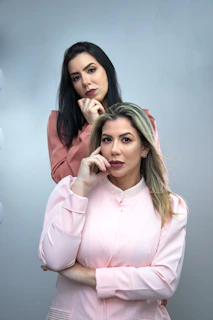 A mother and daughter wearing matching pastel peach cotton loungewear sets, smiling in natural light.