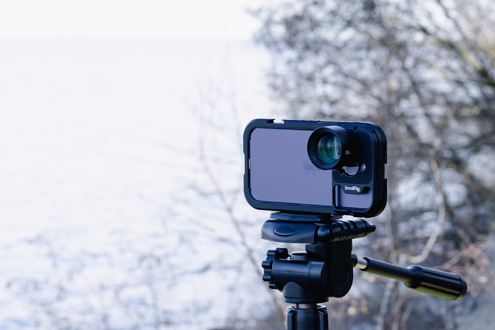 a tripod with a camera attached to it