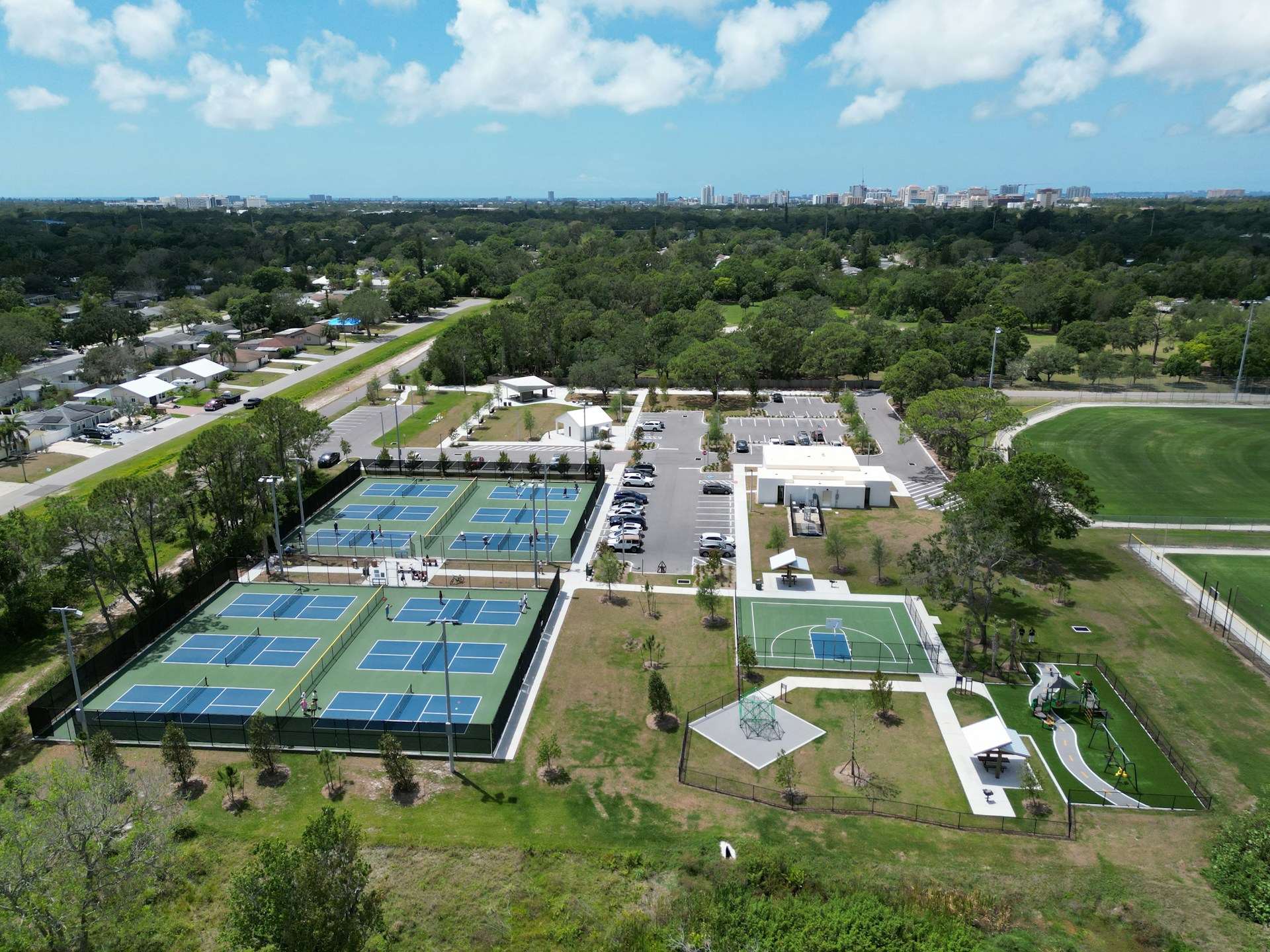 woman wearing yellow long-sleeved dress under white clouds and blue sky during daytime