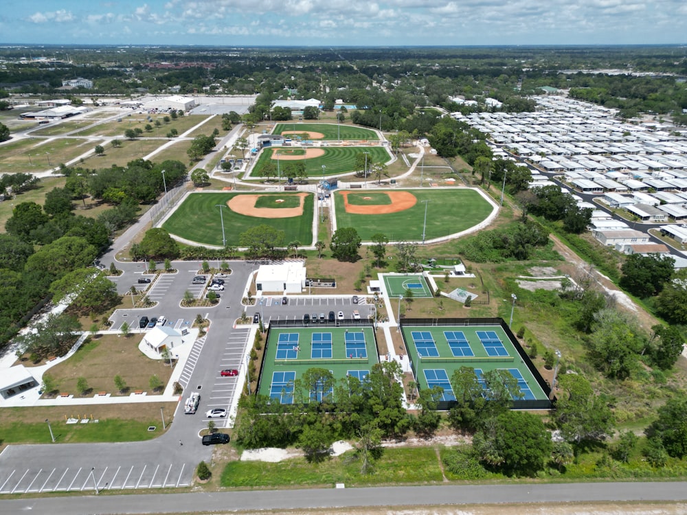 an aerial view of a tennis court and parking lot