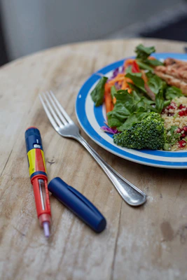 A colorful spread of diabetic-friendly lunch and dinner dishes on a rustic wooden table