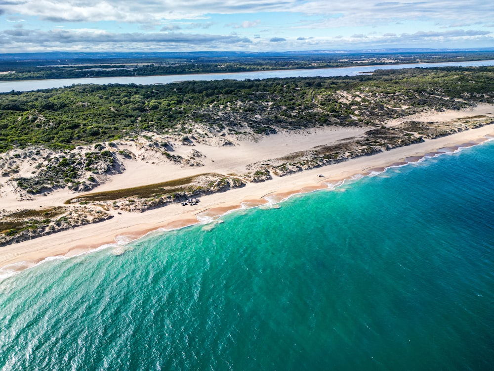 an aerial view of a sandy beach and ocean