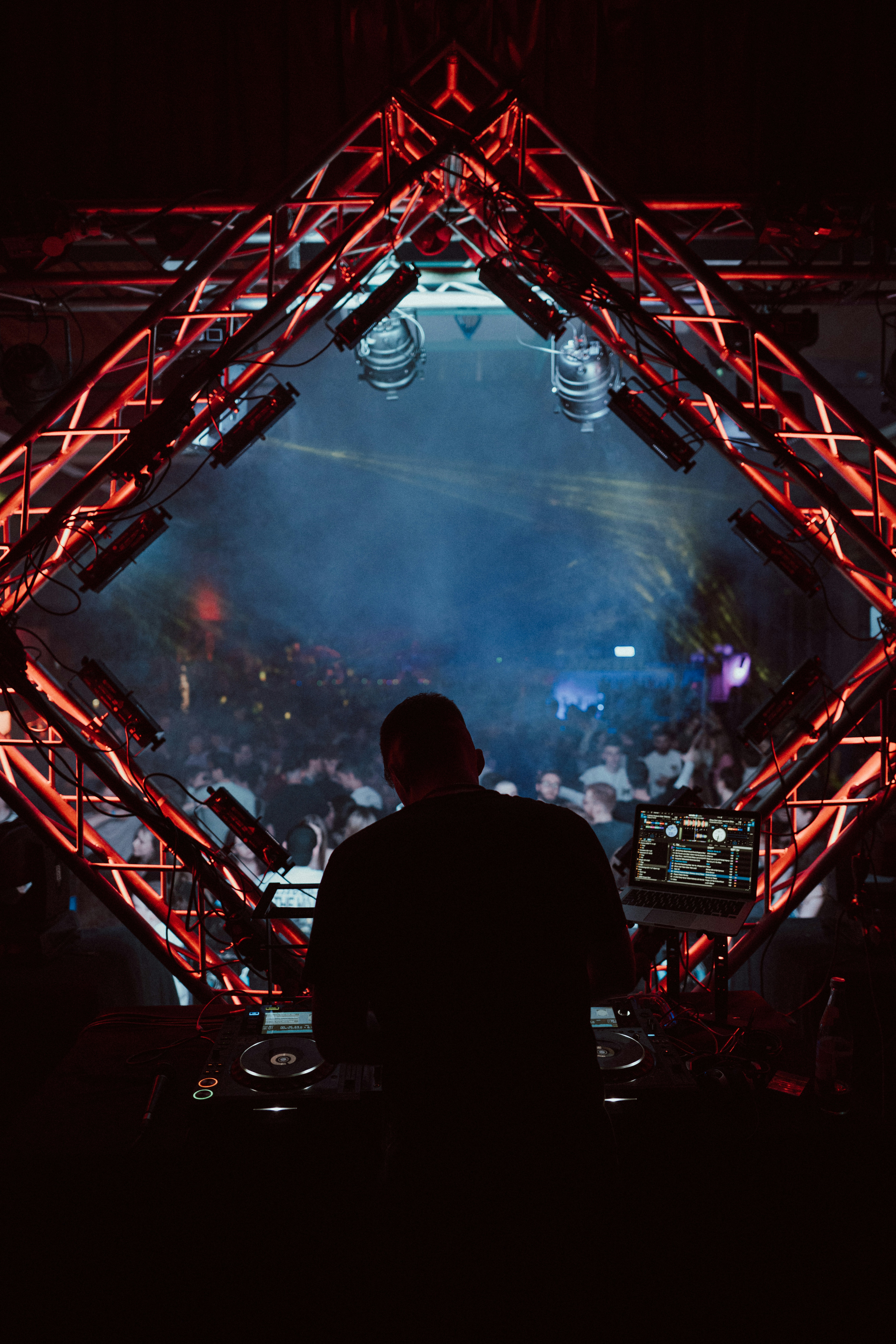a dj in front of a crowd at a concert