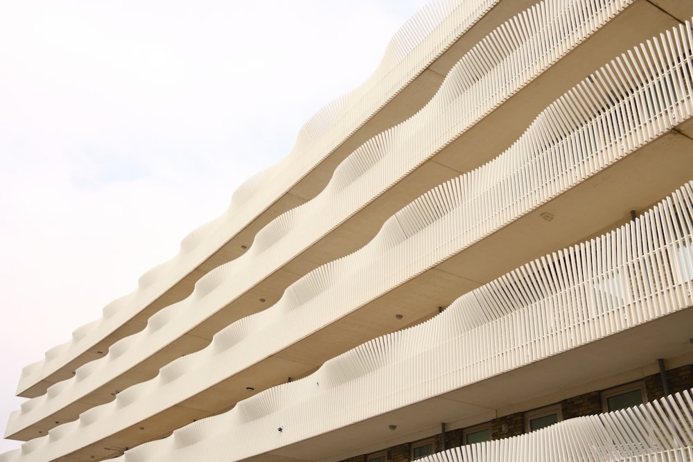 a white building with white balconies against a blue sky