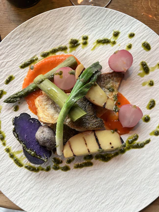 A beautifully plated dish featuring peperoland's signature spicy sauce drizzled over grilled vegetables