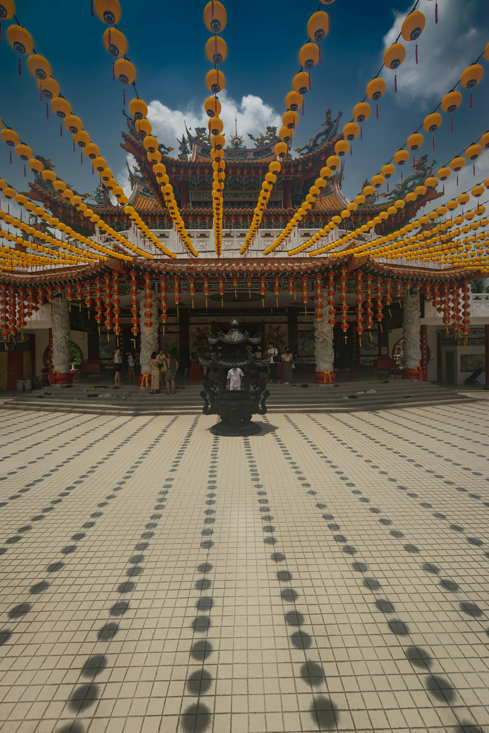 a large building with many yellow umbrellas hanging from it's ceiling