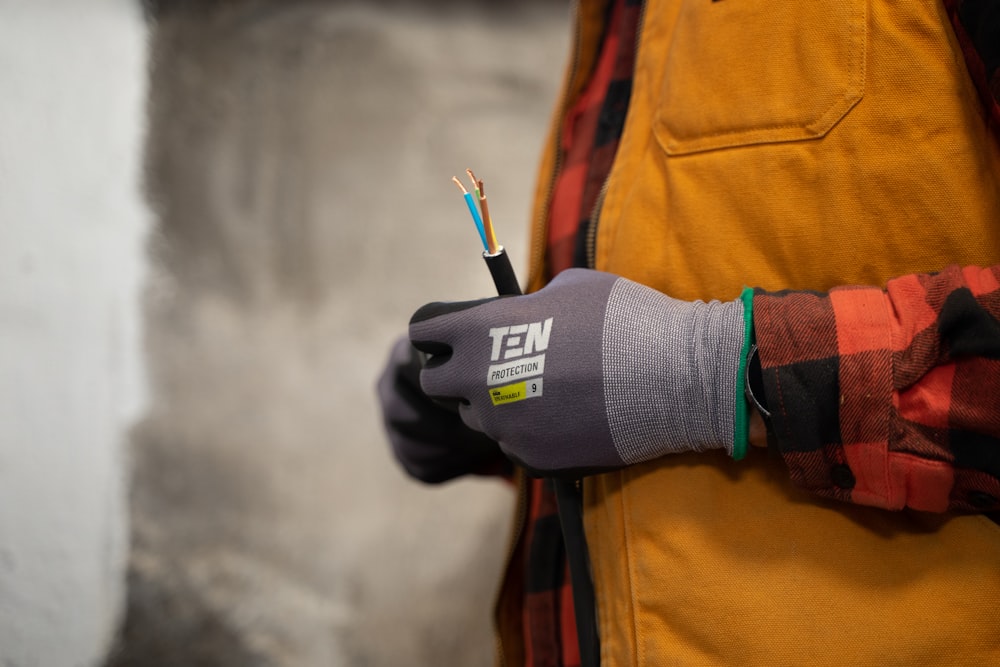 a person holding a pair of wires in their hands