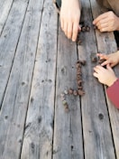 Close-up of hands arranging simple geometric shapes on a table.