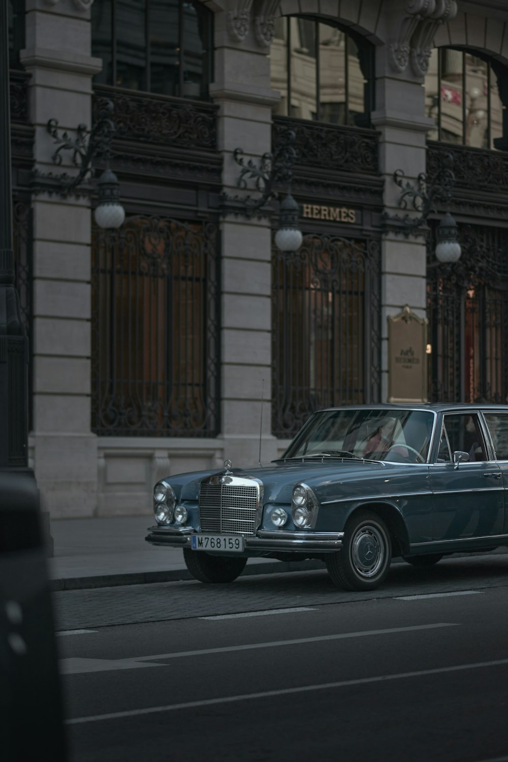 a blue car parked on the side of the road