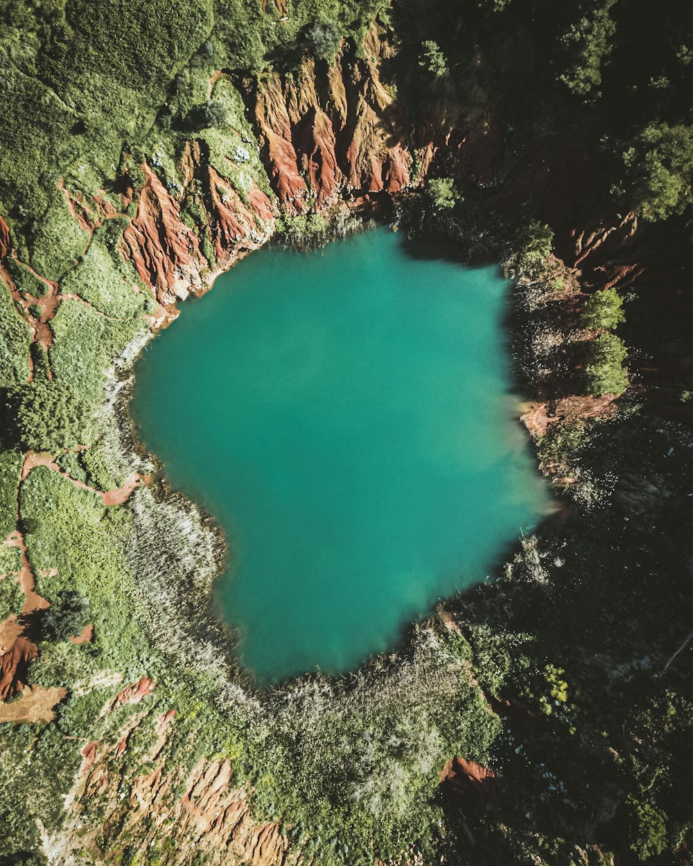 a blue lake surrounded by trees and rocks