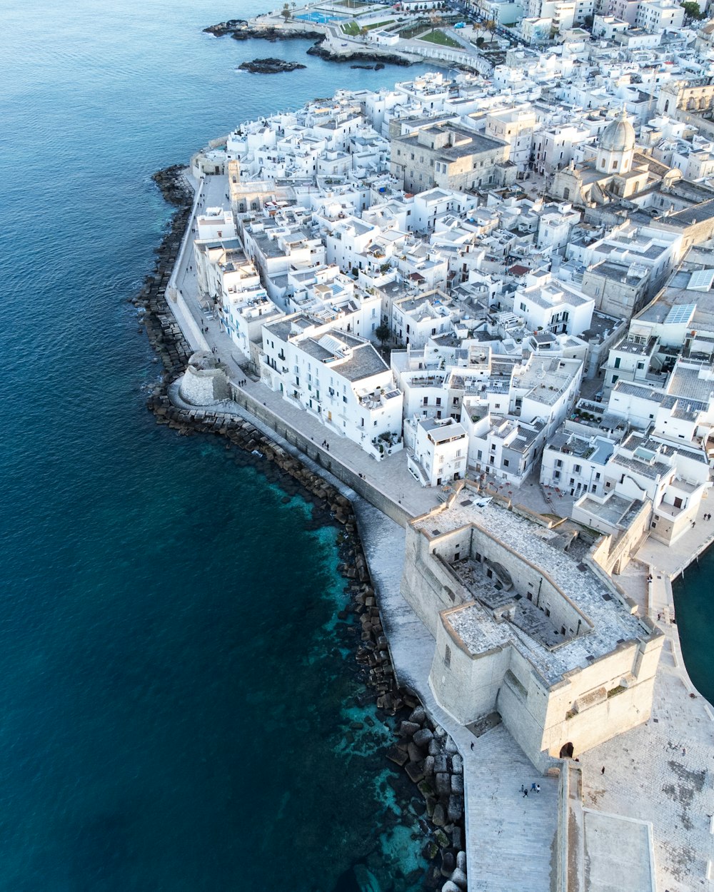 an aerial view of a city next to the ocean