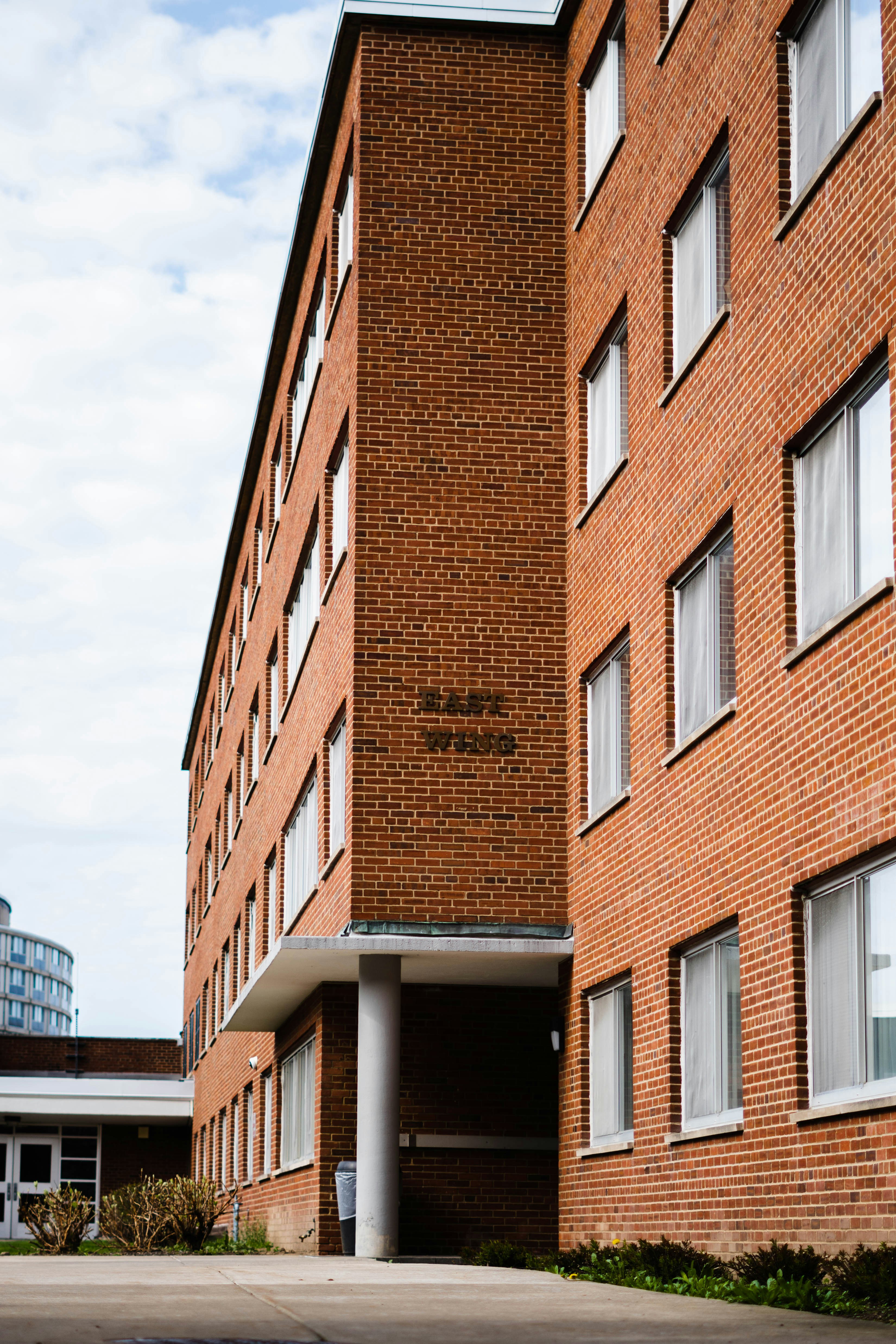 a red brick building with a parking lot in front of it