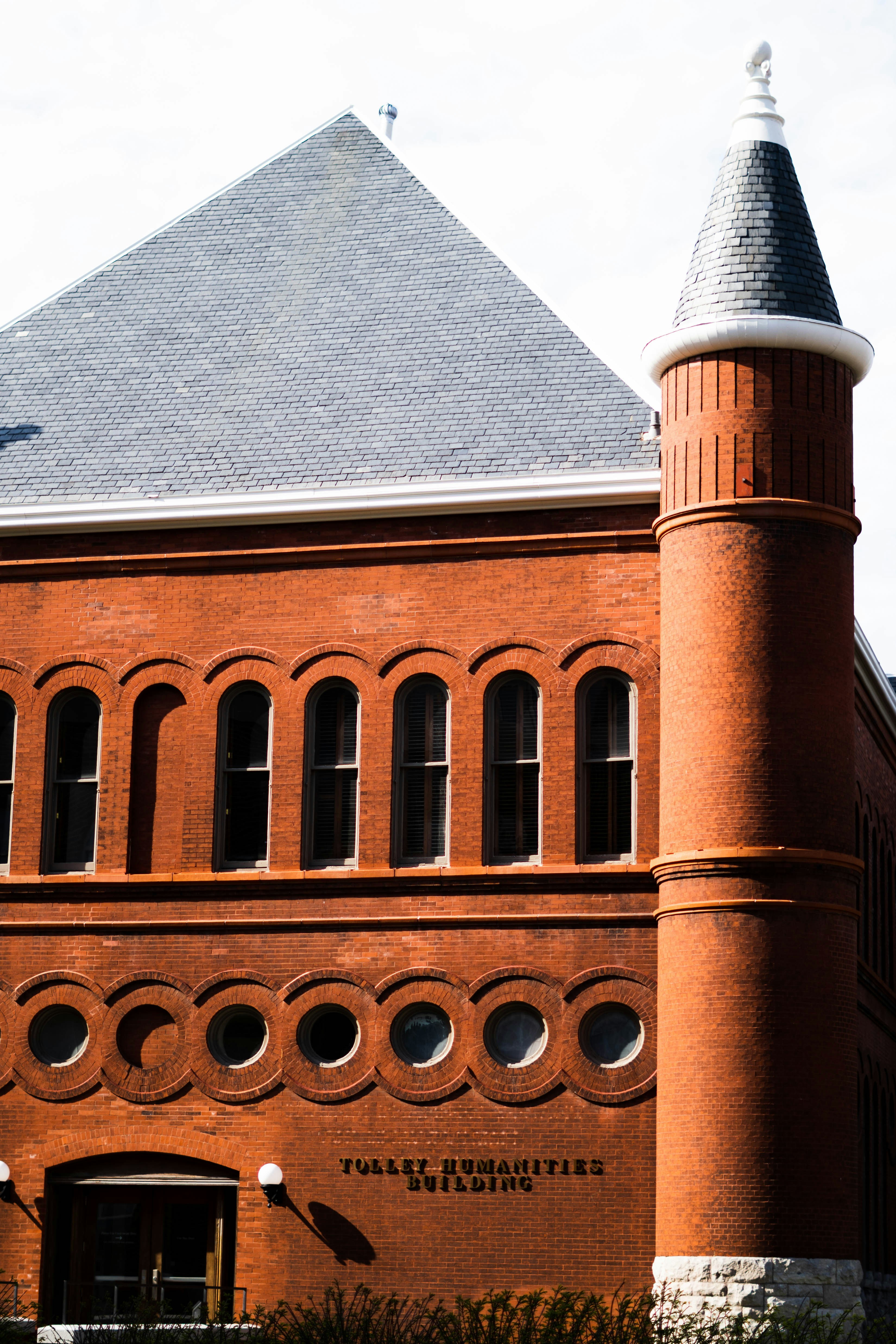 a large red brick building with a clock tower