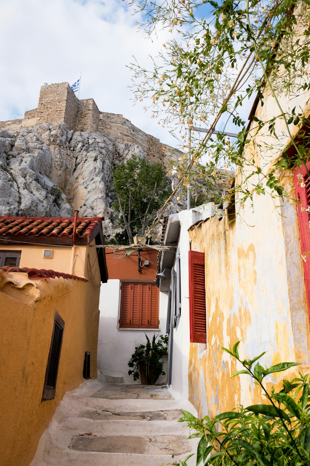 a narrow alley with steps leading up to a building