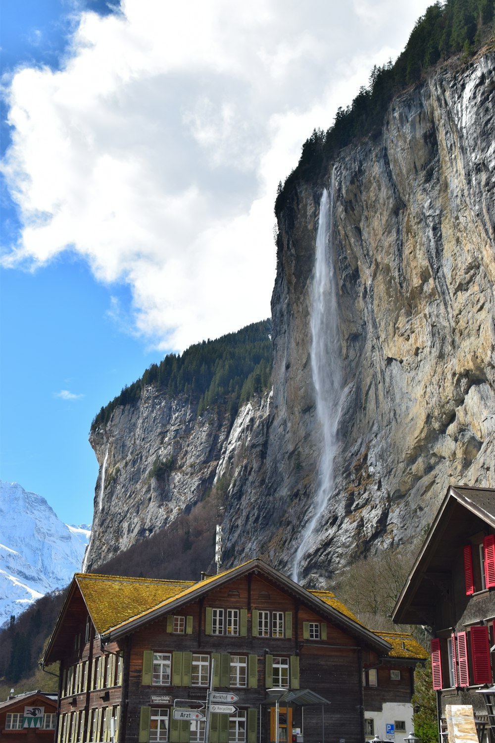 a large waterfall is coming down the side of a mountain