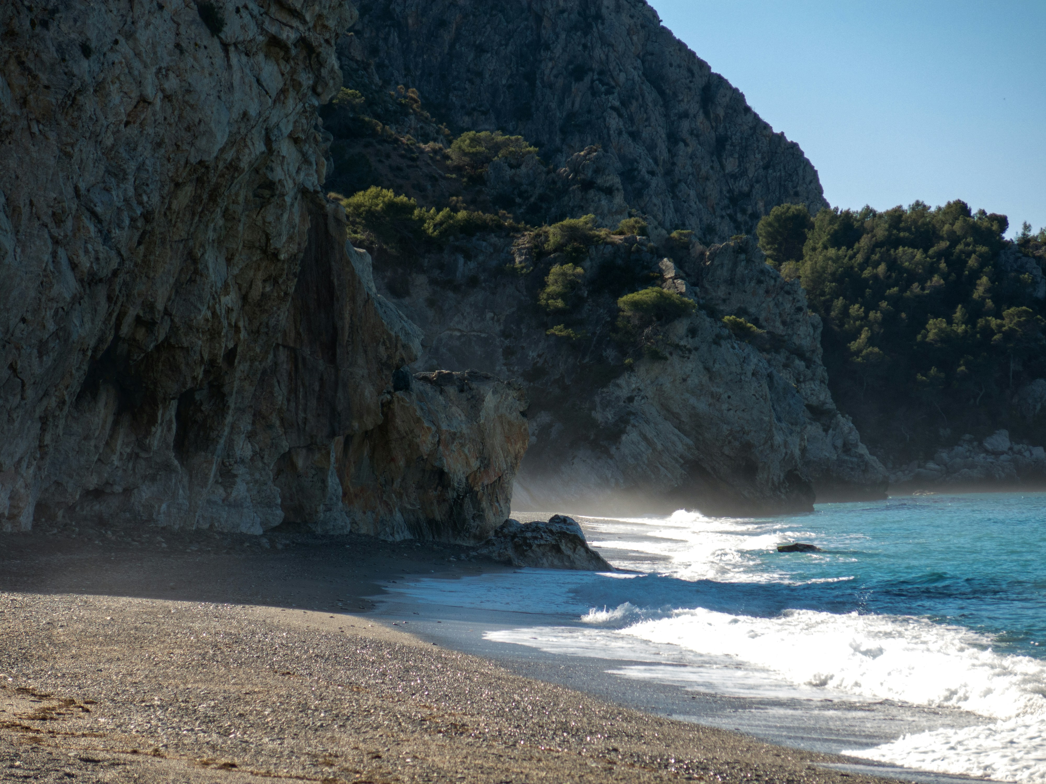 a beach with a cliff on the side of it