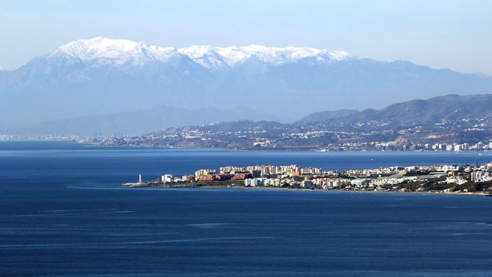 a large body of water with mountains in the background