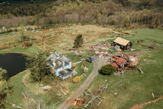an aerial view of a house in the middle of a field