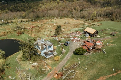 an aerial view of a house in the middle of a field
