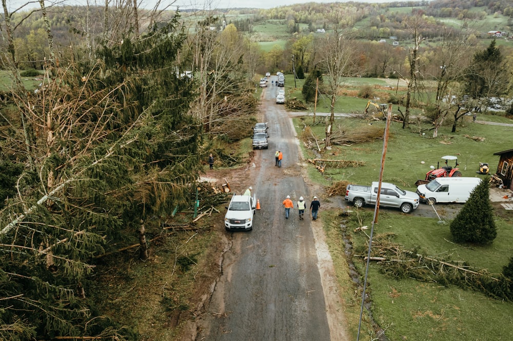 a group of people walking down a dirt road