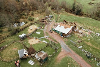 an aerial view of a farm with a dirt road