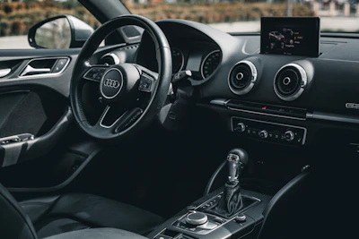 the interior of a car with a steering wheel and dashboard