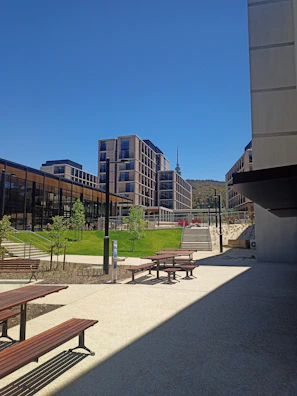 A modern mixed-use development with sleek glass facades and landscaped public spaces.