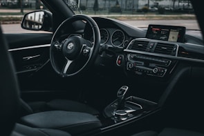 A polished BMW 7 Series interior showcasing premium leather seats, ambient lighting, and built-in Wi-Fi.