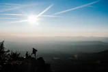 A wide shot of a small group pausing for a rest amid misty mountain trails, looking ahead with determination.