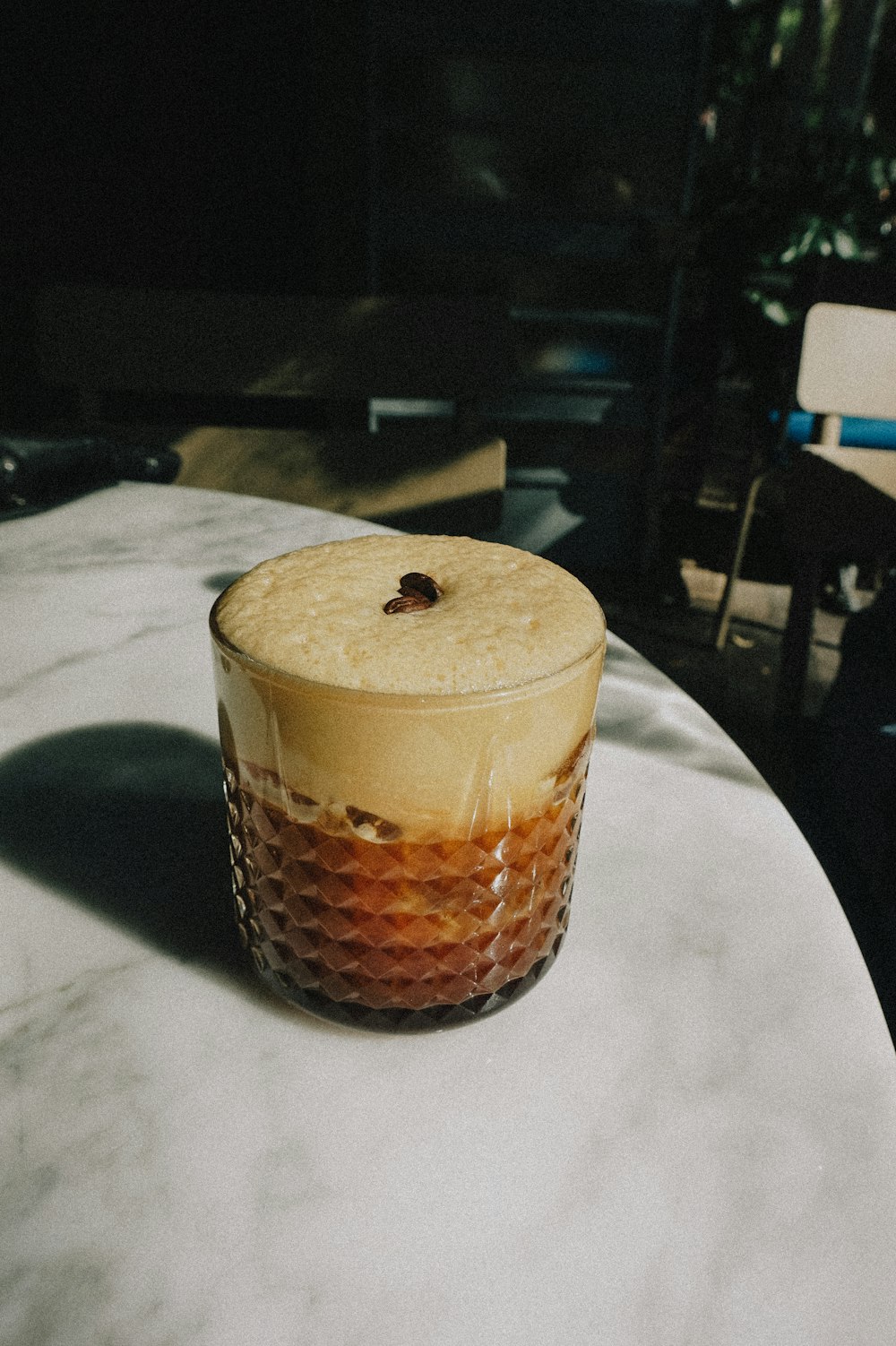 a glass of liquid sitting on top of a table