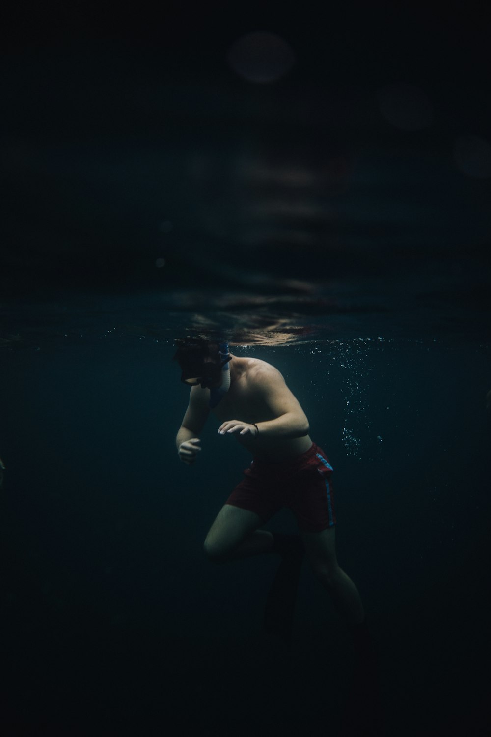 a man swimming under water in the ocean