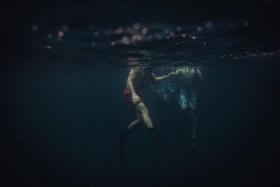Two animated boys in swim gear pointing to their swimming domains.