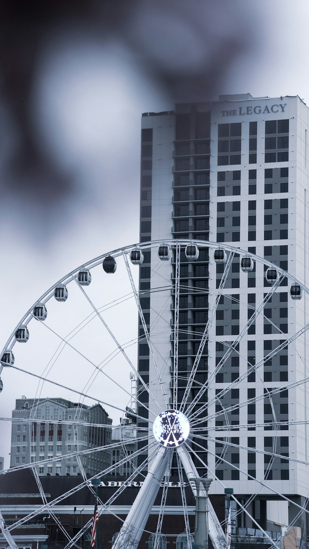 a ferris wheel in front of a tall building