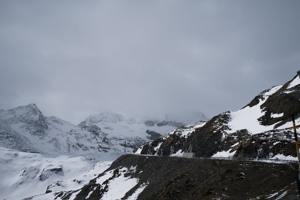 a snow covered mountain with a road going through it