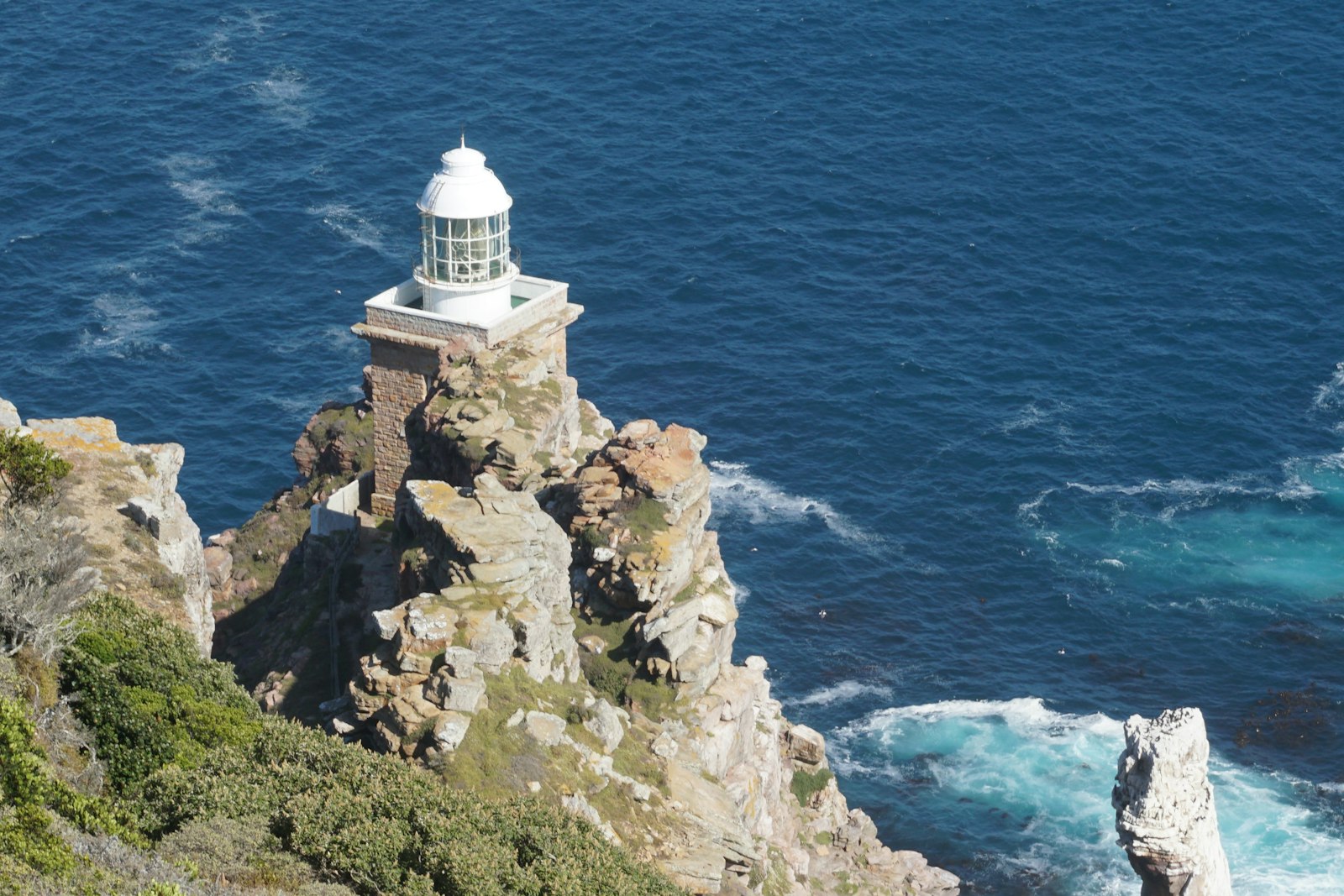 Cape Point lighthouse perched on rugged cliffs above the deep blue Atlantic