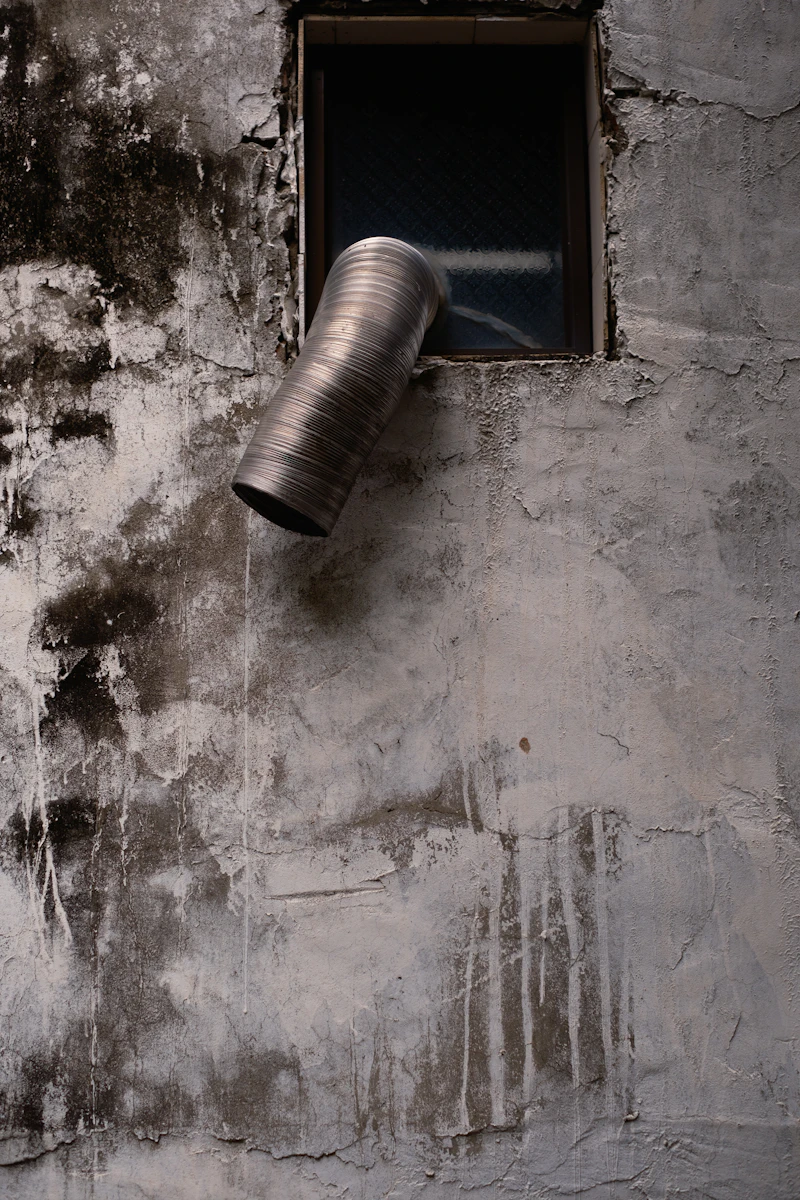 Dryer vent exhaust pipe on exterior wall — professional inspection and cleaning