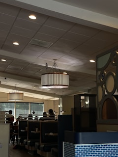 A cozy diner interior with wooden booths and a warm atmosphere, filled with patrons enjoying their meals.