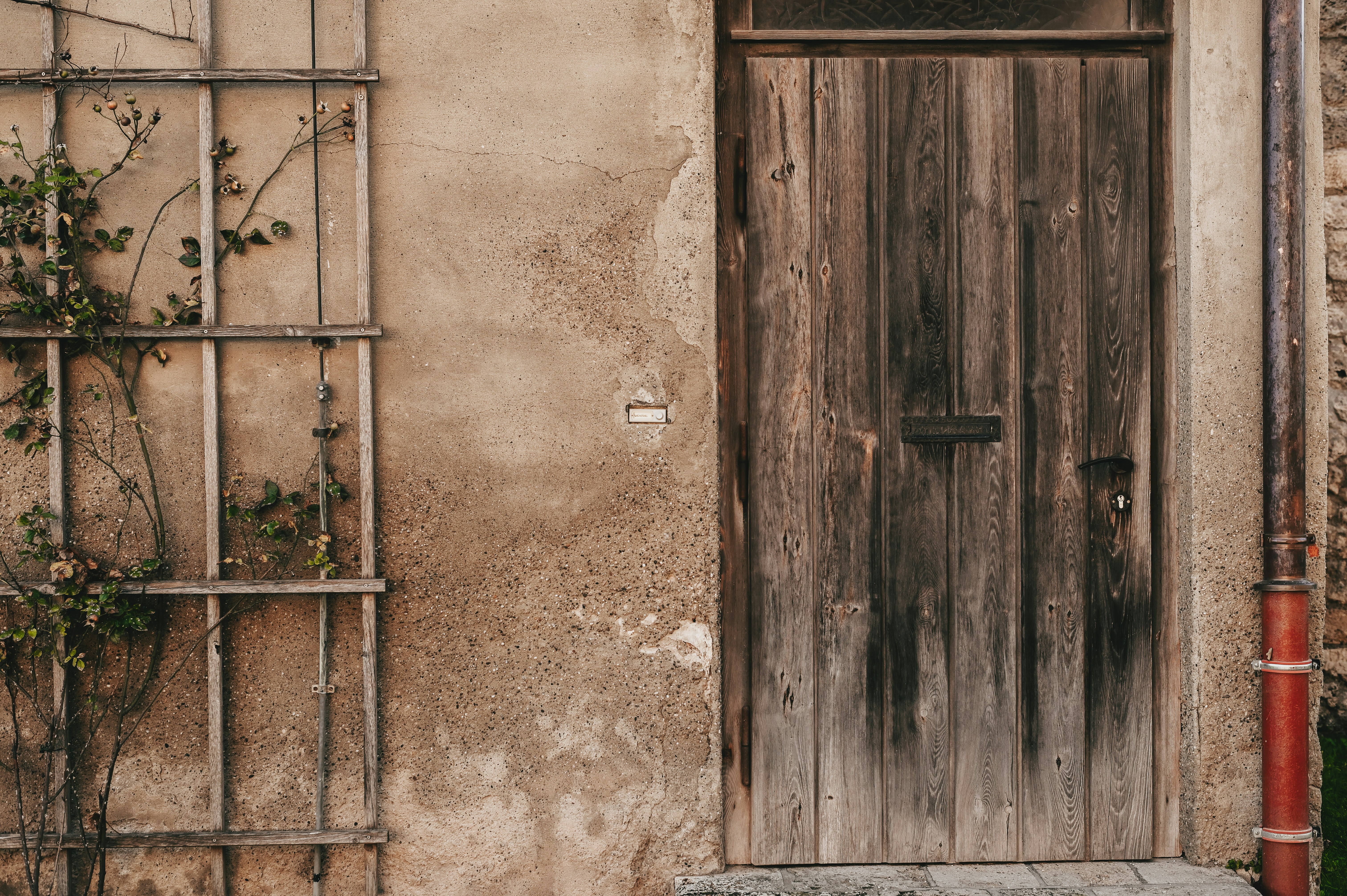 a wooden door sitting next to a building