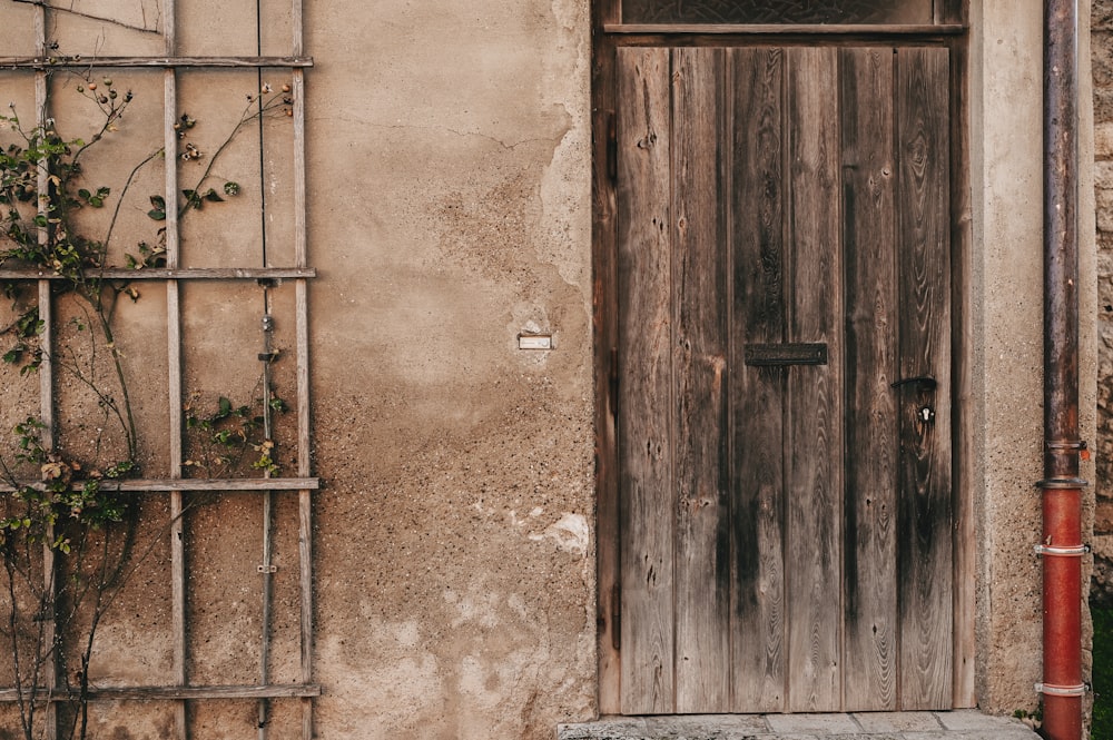 a wooden door sitting next to a building