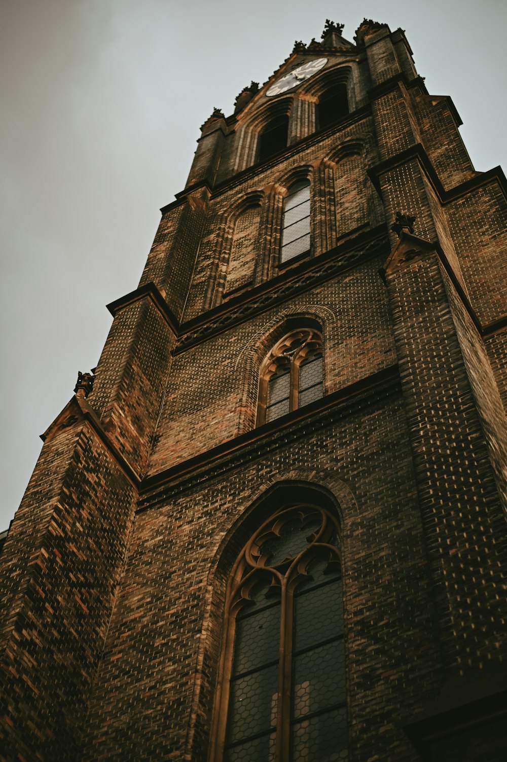 a tall brick building with a clock on it's side