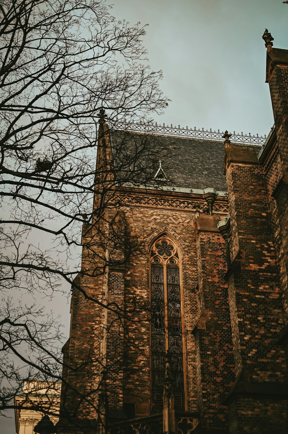 a tall brick building with a clock on it's side