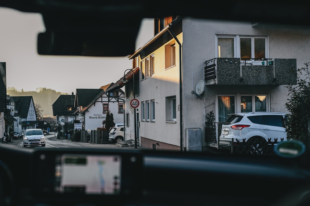 a car driving down a street next to a tall building