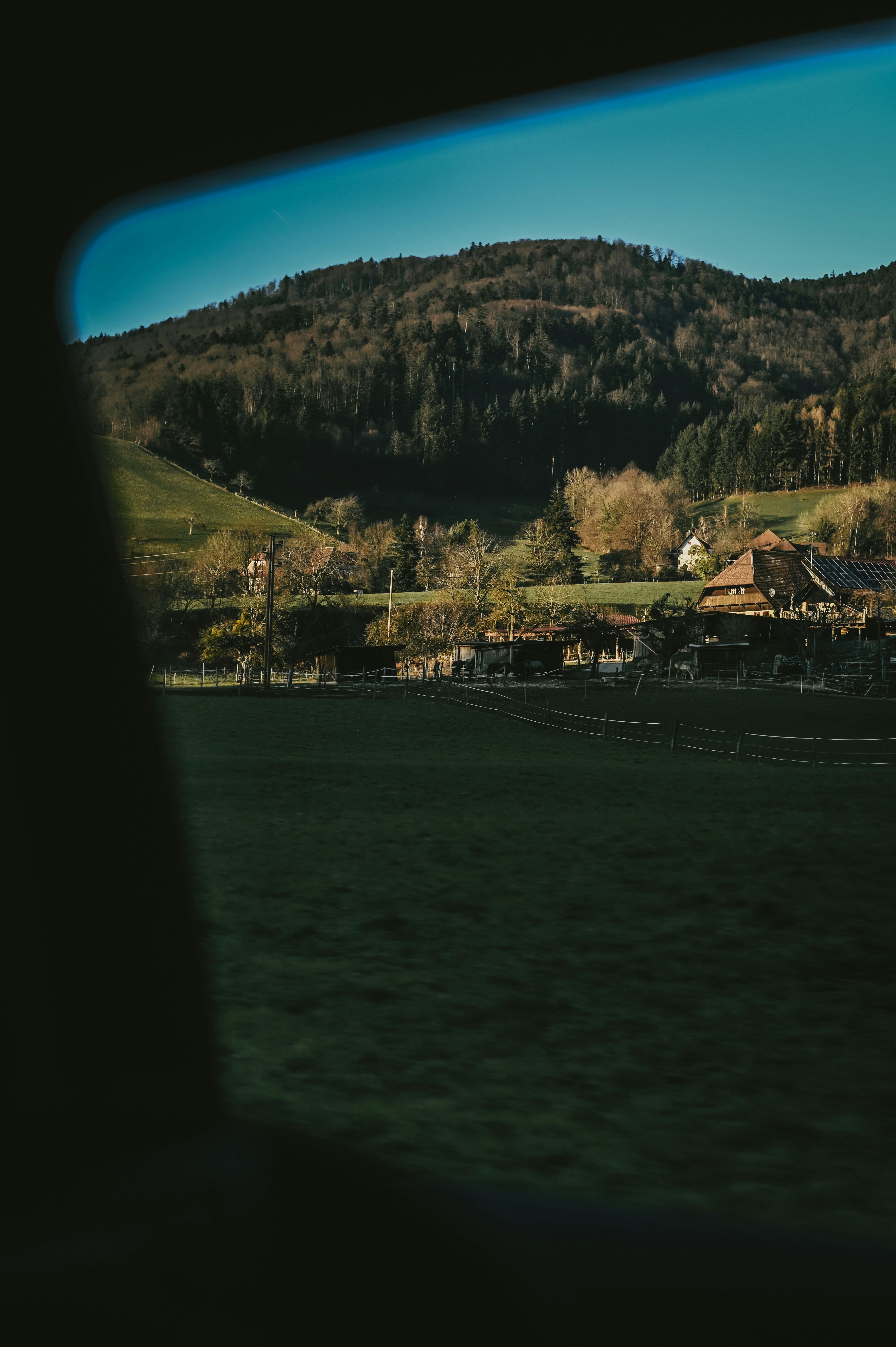 a picture taken from a window of a house in the mountains