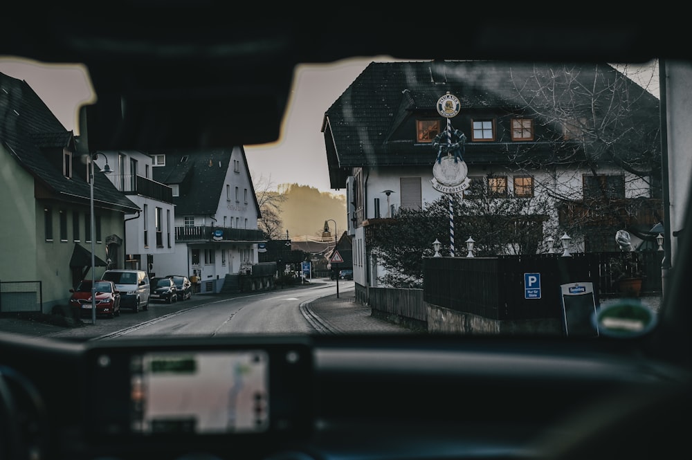 a view from inside a car looking at a street