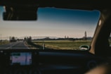 A scenic view of a car being transported through the countryside.