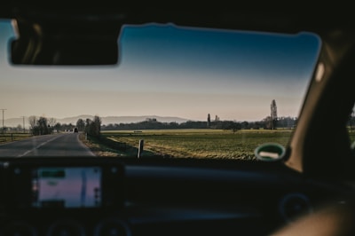 A scenic view of a car being transported through the countryside.