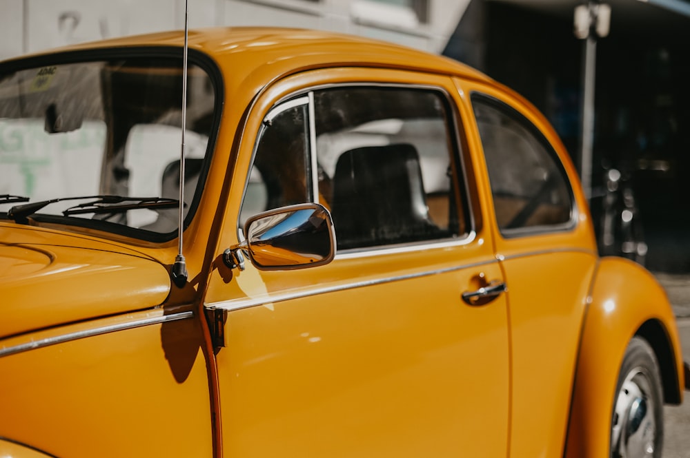 a close up of the side view mirror of a yellow car